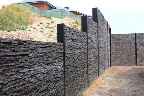 stack stone retaining wall with concrete sleepers