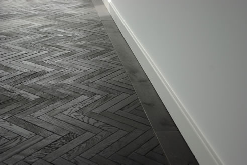 black herringbone timber parquet floor