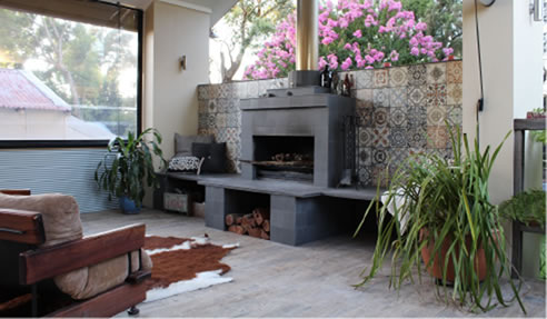 tiled outdoor area with fireplace