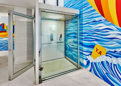 glass lift with mural backdrop