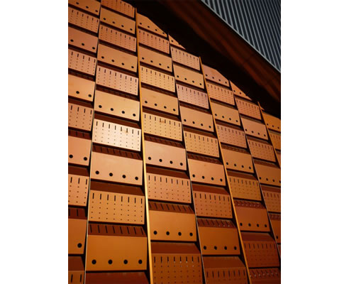 ochre coloured perforated aluminium panels