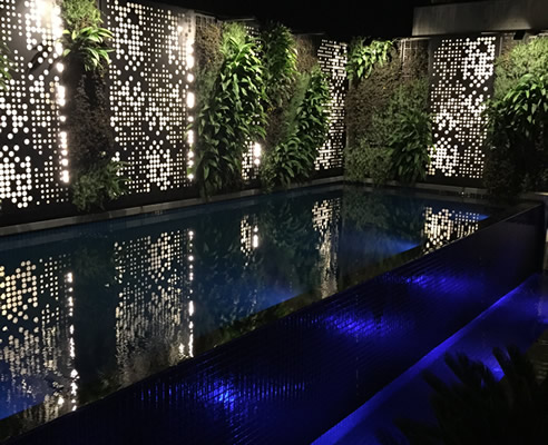 backlit screens and green wall pool surround