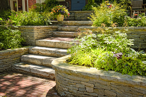 stacked stone retaining wall and stairs