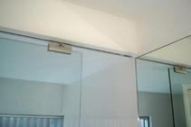 	Flush Set Top Track Frameless Glass Partition by Smooth Door Systems	