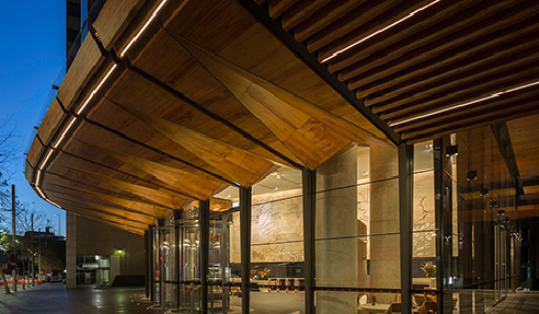 The primary objective of the lighting design was to create a welcoming environment within the public domain of the building, accentuating the warm timber finishes and decluttering the open area with limited light sources.