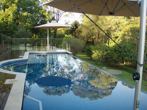 cantilever side post umbrellas over pool