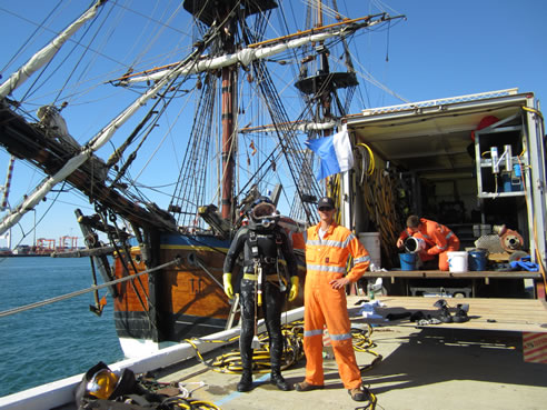diver ready to repair replica ship endeavour hull