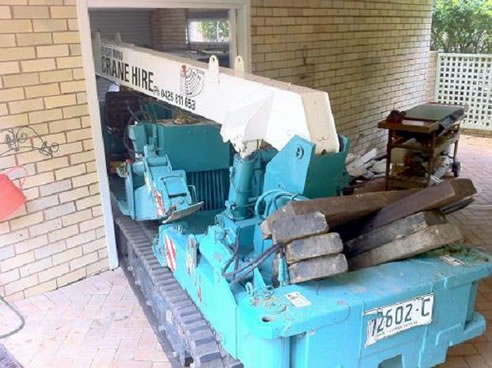 mini crane driving through doorway