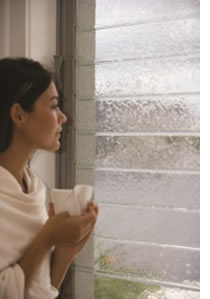 woman looking out louvre window