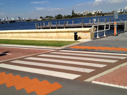 orange tactile ground surface indicators at road crossing