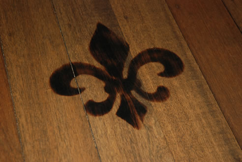 timber floor scorched with fleur de lys pattern