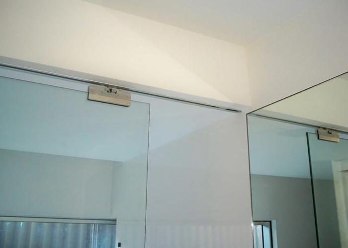 Flush Set Top Track Frameless Glass Partition by Smooth Door Systems