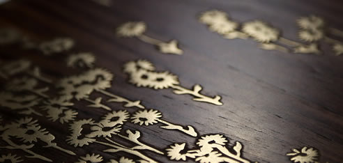 metal flowers inlaid in timber