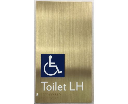 brass disabled toilet sign with braille