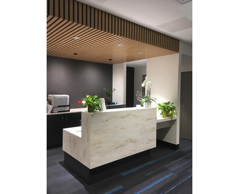 timber slat bulkhead above reception desk