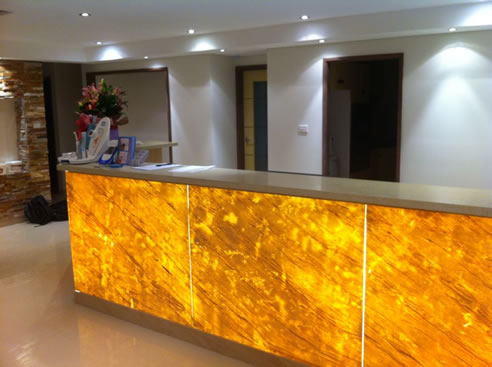 backlit stone clad reception desk