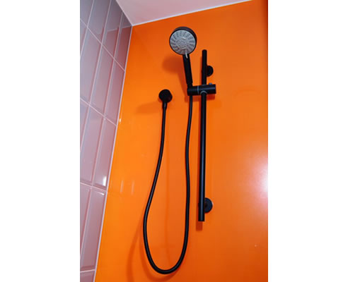 orange acrylic shower splashback