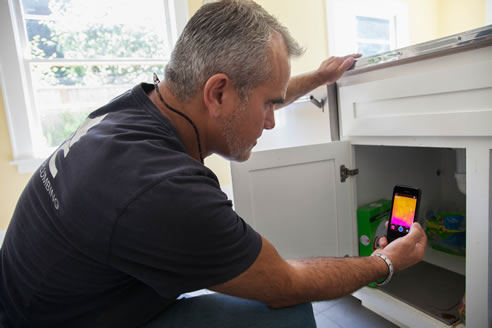 tradesman using flir iphone thermal imager