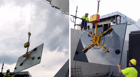 mini crane lowers glass panel