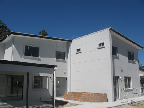 house clad with pre rendered insulated panels