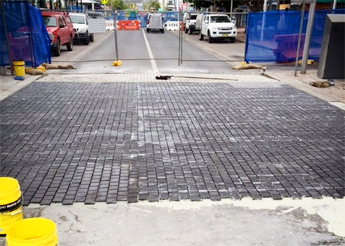 Granite cobblestone being installed from LATICRETE