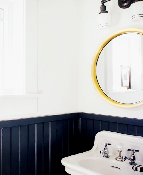 Typically painted in white, you can also add colour to create a more modern interior such as this navy bathroom. Image courtesy of Apartment Therapy.
