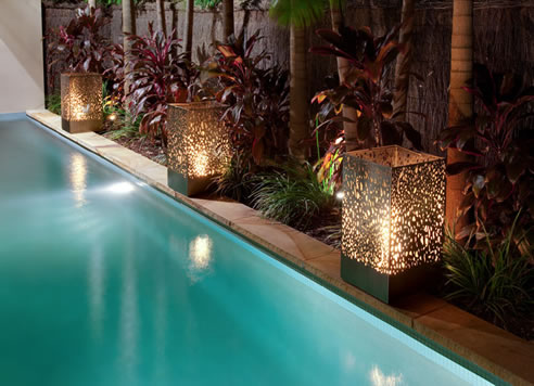 contained decorative outdoor fireplaces beside pool