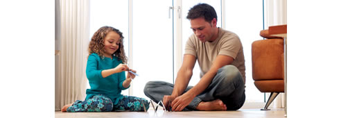 father and daughter sitiing on heated floor