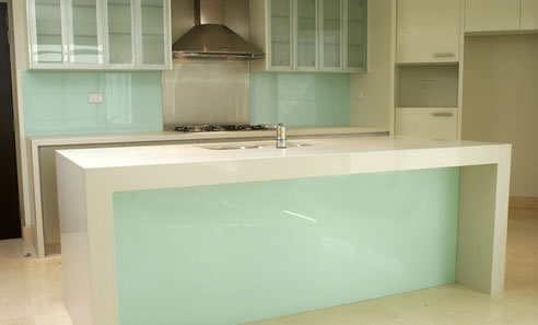 glass splashbacks and matching glass kitchen island feature