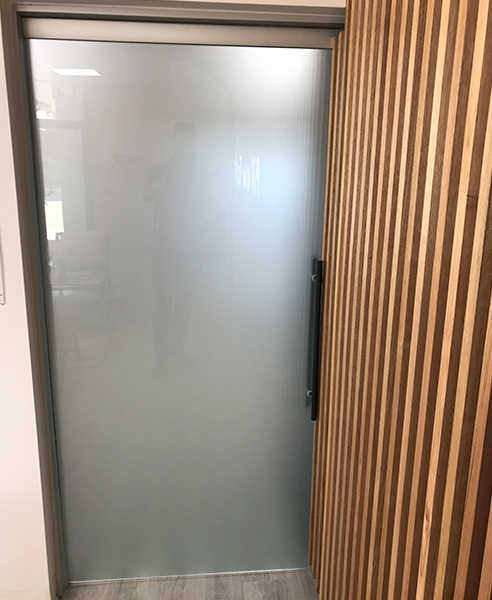 Interior Cavity Slider with Acid Etched Frameless Glass Door